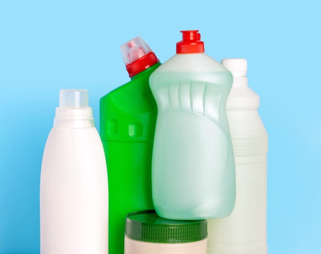 Bottles of cleaning products for the home on a blue background. Cleaning of the apartment