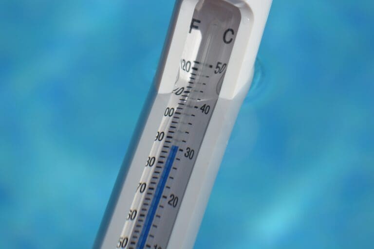 Summer vacation, swimming pool thermometer showing the water temperature of 30c