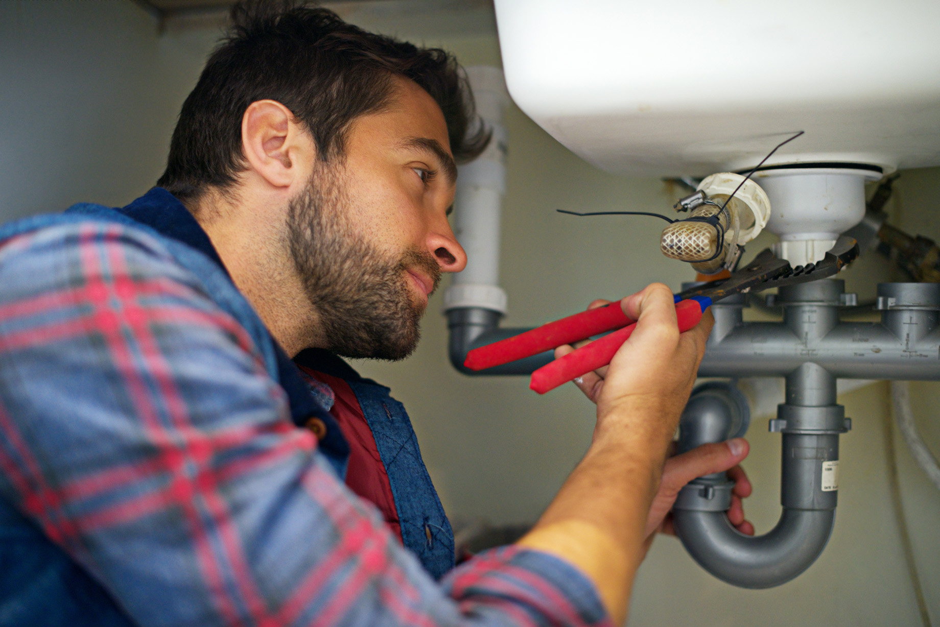 A Professional Fixing the Sink