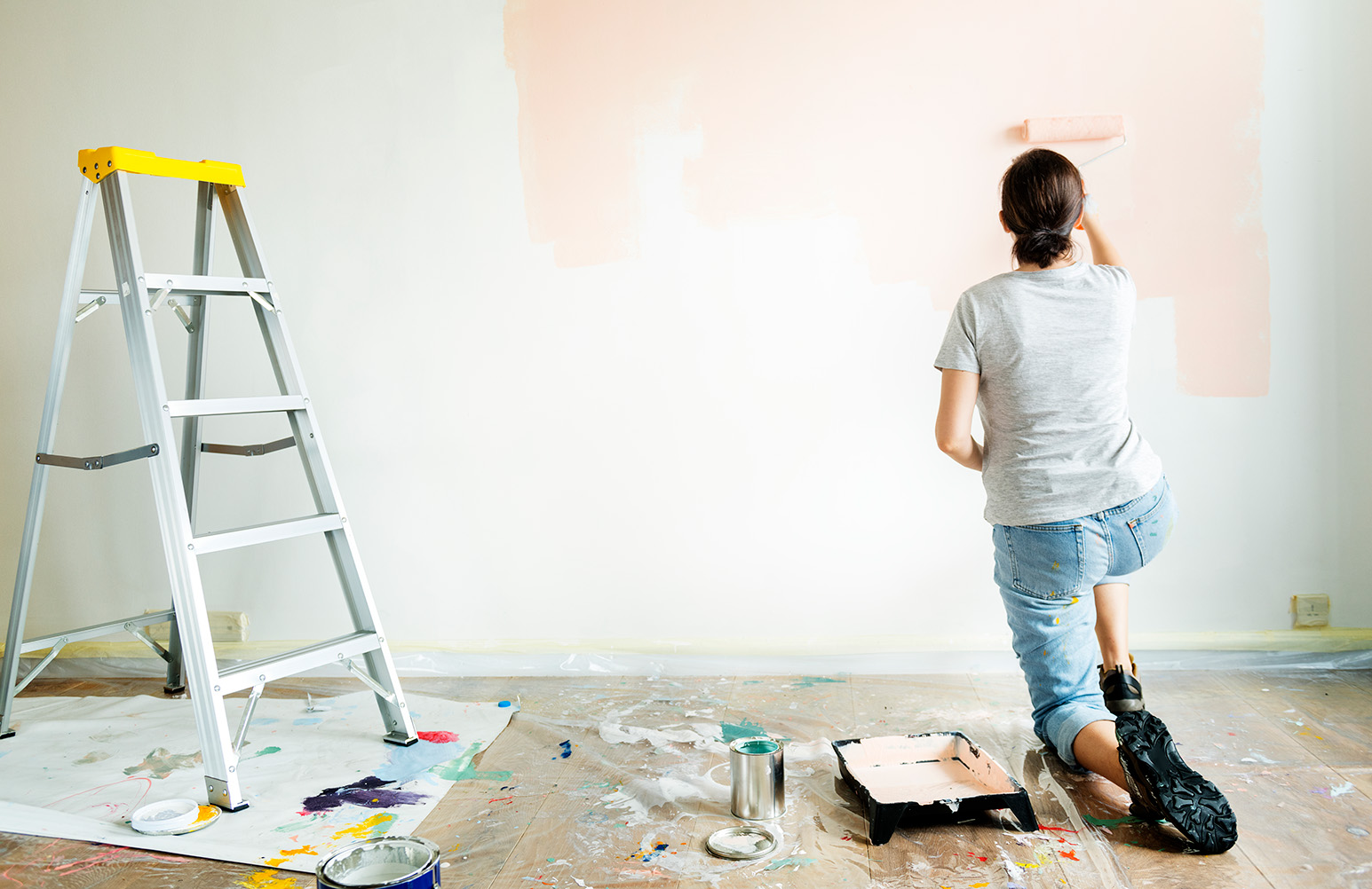 Woman Painting A Wall